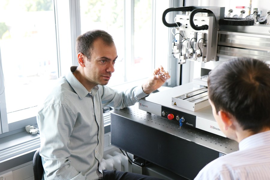 Dr. Ivan Minev in front of his 3D printer